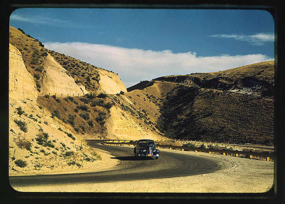 Road cut into the barren hills which lead into Emmett. Emmett, Idaho, July 1941. Reproduction from color slide. Photo by Russell Lee. Prints and Photographs Division, Library of Congress